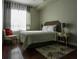 Cozy bedroom with dark hardwood floors, a patterned rug, and a plush bed at 171 Auburn Ave # 329, Atlanta, GA 30303