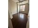 Well-lit bedroom featuring hardwood floors, a ceiling fan, and a large window at 171 Auburn Ave # 329, Atlanta, GA 30303