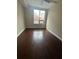 Bedroom featuring hardwood floors, large windows, and neutral paint for a comfortable living space at 171 Auburn Ave # 329, Atlanta, GA 30303