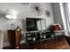 Relaxing living room with media center, accent chair, unique wall decorations and hardwood floors at 171 Auburn Ave # 329, Atlanta, GA 30303