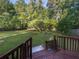 Expansive backyard view from the deck featuring lush lawn, mature trees, and wood fencing at 3371 Vandiver Dr, Marietta, GA 30066