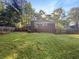 Large grassy backyard view, showing the deck, chimney, and the back exterior of the home at 3371 Vandiver Dr, Marietta, GA 30066