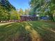 Charming brick home with a well-manicured lawn and mature trees at 3371 Vandiver Dr, Marietta, GA 30066