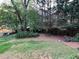 Backyard with bench surrounded by mature trees and landscaping at 5741 Wolf Laurel, Lilburn, GA 30047