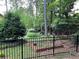 Fenced-in backyard with garden bed surrounded by large mature trees at 5741 Wolf Laurel, Lilburn, GA 30047