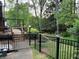Backyard with black aluminum fence, landscaping and stairs leading to a deck at 5741 Wolf Laurel, Lilburn, GA 30047