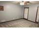 A view of a bedroom with neutral colored walls, carpet flooring, and a ceiling fan at 5741 Wolf Laurel, Lilburn, GA 30047