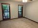 A bedroom with neutral walls, carpeted flooring, and natural light from the trees outside at 5741 Wolf Laurel, Lilburn, GA 30047