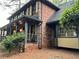 Side view of a brick two story home with large front porch at 5741 Wolf Laurel, Lilburn, GA 30047