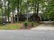 Charming brick home with mature trees, landscaped yard, and long driveway at 5741 Wolf Laurel, Lilburn, GA 30047