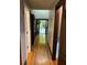 Inviting hallway with hardwood floors leads to the entryway and stairs, creating a warm transition at 5741 Wolf Laurel, Lilburn, GA 30047