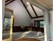 Living area with vaulted ceiling, carpet, wainscoting and beams at 5741 Wolf Laurel, Lilburn, GA 30047
