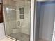 Modern tiled shower with glass door and mosaic tile flooring at 5741 Wolf Laurel, Lilburn, GA 30047