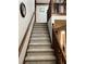 Carpeted stairway with stained wood trim leads to the second floor at 5741 Wolf Laurel, Lilburn, GA 30047