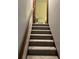 Carpeted stairway with a wooden handrail provides a seamless transition between floors in this lovely home at 5741 Wolf Laurel, Lilburn, GA 30047