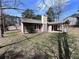 Back exterior view with covered porch and lush lawn, perfect for outdoor enjoyment at 5947 Rock Rd, Union City, GA 30291