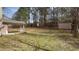 Large, private backyard featuring a shed, mature trees, and plenty of green space at 5947 Rock Rd, Union City, GA 30291