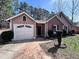Front exterior of home showcasing brick accents, attached garage, and well-maintained lawn at 5947 Rock Rd, Union City, GA 30291