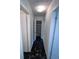 Hallway featuring unique black marble flooring and an open shelved linen closet for ample storage at 5947 Rock Rd, Union City, GA 30291