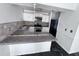 Functional kitchen featuring white cabinets, tiled backsplash, and black appliances at 5947 Rock Rd, Union City, GA 30291