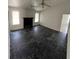 Spacious living room with fireplace, black marble tile, and ample natural light at 5947 Rock Rd, Union City, GA 30291