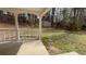 Covered porch leading to backyard with view of shed and lush greenery at 5947 Rock Rd, Union City, GA 30291