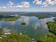 Beautiful aerial view of lake surrounded by lush greenery under a partly cloudy sky at 7 Yachting Way, Acworth, GA 30102