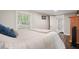 Bright bedroom featuring hardwood floors, a window with natural light, and en-suite bathroom at 7 Yachting Way, Acworth, GA 30102