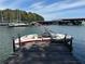 Boat with a red stripe docked next to a marina and surrounded by blue skies at 7 Yachting Way, Acworth, GA 30102