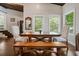 Dining room with a wooden table, bench, chairs, and view of the green outdoors at 7 Yachting Way, Acworth, GA 30102