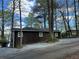 Exterior view of a single Gathering house with dark brown siding at 7 Yachting Way, Acworth, GA 30102