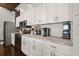Bright kitchen with white cabinetry, stainless steel appliances, and granite counters at 7 Yachting Way, Acworth, GA 30102
