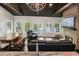 Open-concept living space with stone fireplace, lake views, dining area, and wood-beamed ceilings at 7 Yachting Way, Acworth, GA 30102