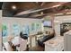 Living room with wood floors, stone fireplace, leather seating and a lake view at 7 Yachting Way, Acworth, GA 30102