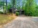 Two-story home with bay windows surrounded by mature trees and a private driveway at 2864 Sudbury Ct, Marietta, GA 30062