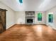 Open living room featuring hardwood floors, stone fireplace, skylights, a sliding barn door, and access to the deck at 2864 Sudbury Ct, Marietta, GA 30062
