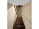A wood staircase overlooking a lower level space with neutral paint, wood floors and brick fireplace at 2864 Sudbury Ct, Marietta, GA 30062