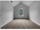 An empty carpeted room with a window and vaulted ceilings at 3542 Broad Oak Ct, Decatur, GA 30034