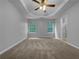 Spacious primary bedroom with tray ceilings, carpet, and an ensuite bathroom at 3542 Broad Oak Ct, Decatur, GA 30034