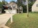 Charming two-story home with a two-car garage, mailbox and green lawn at 3542 Broad Oak Ct, Decatur, GA 30034