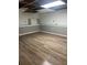 Basement featuring new flooring and paneling, showcasing a partially finished space with bright overhead lighting at 1433 Woodland Sw Ter, Atlanta, GA 30311