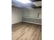 Basement space featuring new vinyl plank flooring and updated wainscoting, ready for personalization at 1433 Woodland Sw Ter, Atlanta, GA 30311