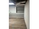Unfinished basement space with built-in shelves and modern flooring, perfect for future expansion at 1433 Woodland Sw Ter, Atlanta, GA 30311
