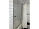 Bathroom featuring a white bathtub with a shower curtain and subway tile at 1433 Woodland Sw Ter, Atlanta, GA 30311