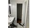 Modern bathroom featuring a sleek black countertop, white sink, and tiled walls at 1433 Woodland Sw Ter, Atlanta, GA 30311