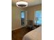 Comfortable bedroom showcasing hardwood floors, a decorative ceiling fan, and a bright window at 1433 Woodland Sw Ter, Atlanta, GA 30311