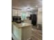 Kitchen with new flooring, island, and stainless steel appliances at 1433 Woodland Sw Ter, Atlanta, GA 30311