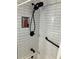 Modern shower features white subway tiles, a built-in niche and a rain style shower head at 1433 Woodland Sw Ter, Atlanta, GA 30311
