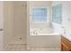 Bright bathroom featuring a separate shower and bathtub with tile flooring at 402 Lafayette St, Dallas, GA 30157
