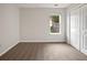 Cozy bedroom featuring neutral carpet, a window for natural light, and a spacious closet at 402 Lafayette St, Dallas, GA 30157